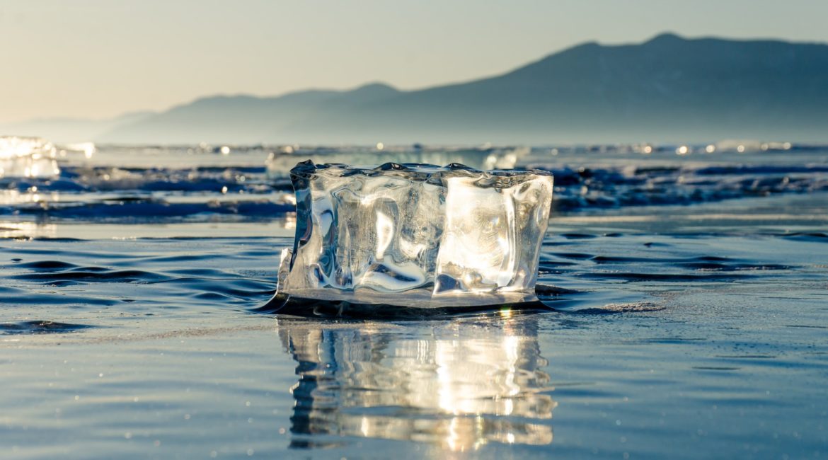 ice block on calm body of water during daytime